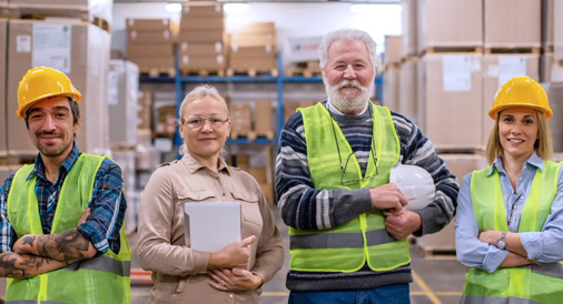 4 People in a warehouse waering safety gear